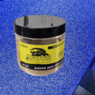 Jar of Gator anti-slip additive with yellow label and black lid, placed on a blue speckled surface.
