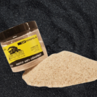 Jar of Gator anti-slip additive tilted beside a mound of beige powder on a dark textured surface.