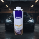 Bas de caisse auto en arrière-plan 2 - PredaColor Tall white and purple spray can labeled 'Antigravel 460' in front of a dark car in a workshop.