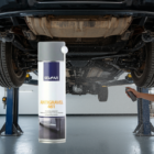 Person applying SEIGAR Antigravel 461 protective coating under a car on a lift with a spray can visible nearby.