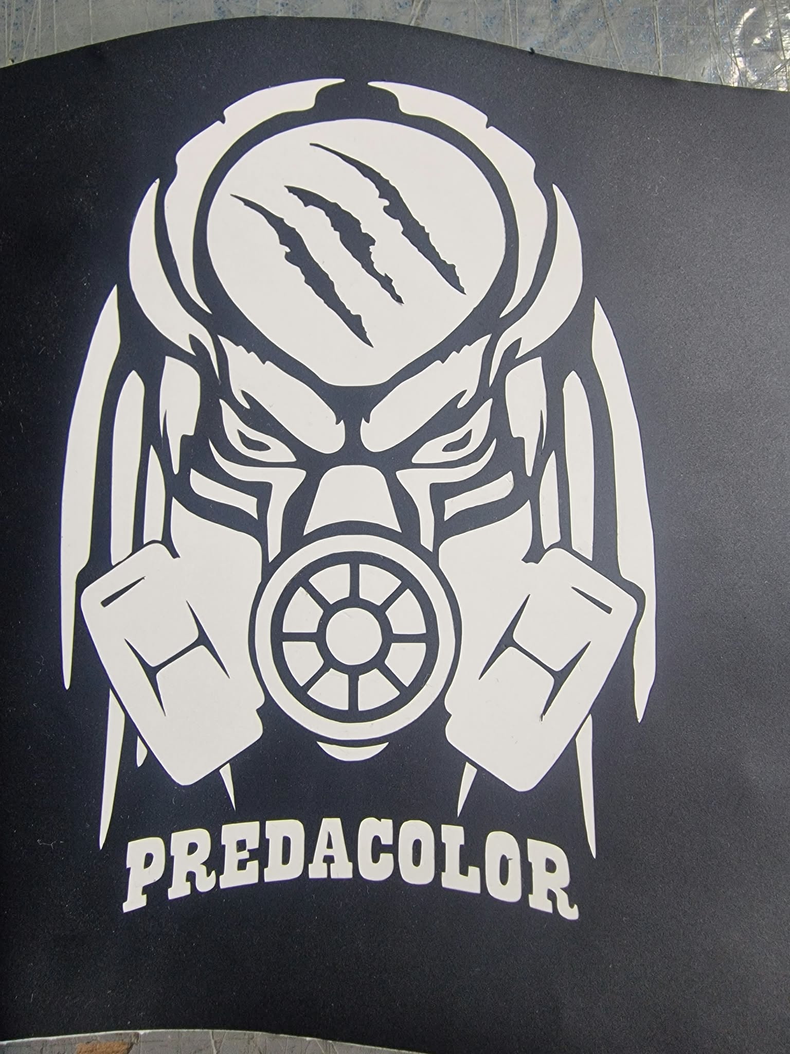 POCHOIR - PredaColor White stylized gas-mask logo on a dark background, with the text PREDACOLOR beneath.