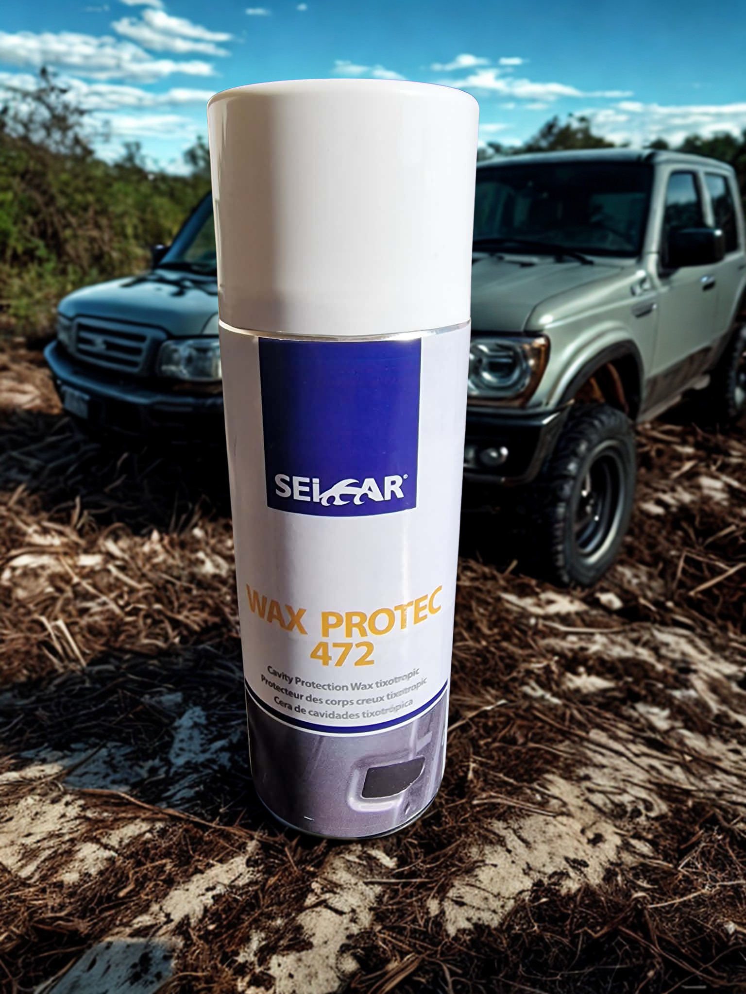 e8889d57-5fe7-4307-b1be-66c06f5b28f9 - PredaColor Close-up of a tall white cylindrical container labeled 'WAX PROTEC 472' in the foreground, with an off-road SUV in a dirt lot blurred in the background.