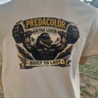 8 DOS - PredaColor Back of a beige T-shirt with a bold graphic of an alligator lifting a barbell and the text 'PREDACOLOR GATOR LINER BUILT TO LAST EST. 2014'